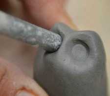 poking something in clay (photo credit: Red and the Peanut.blogspot.com)